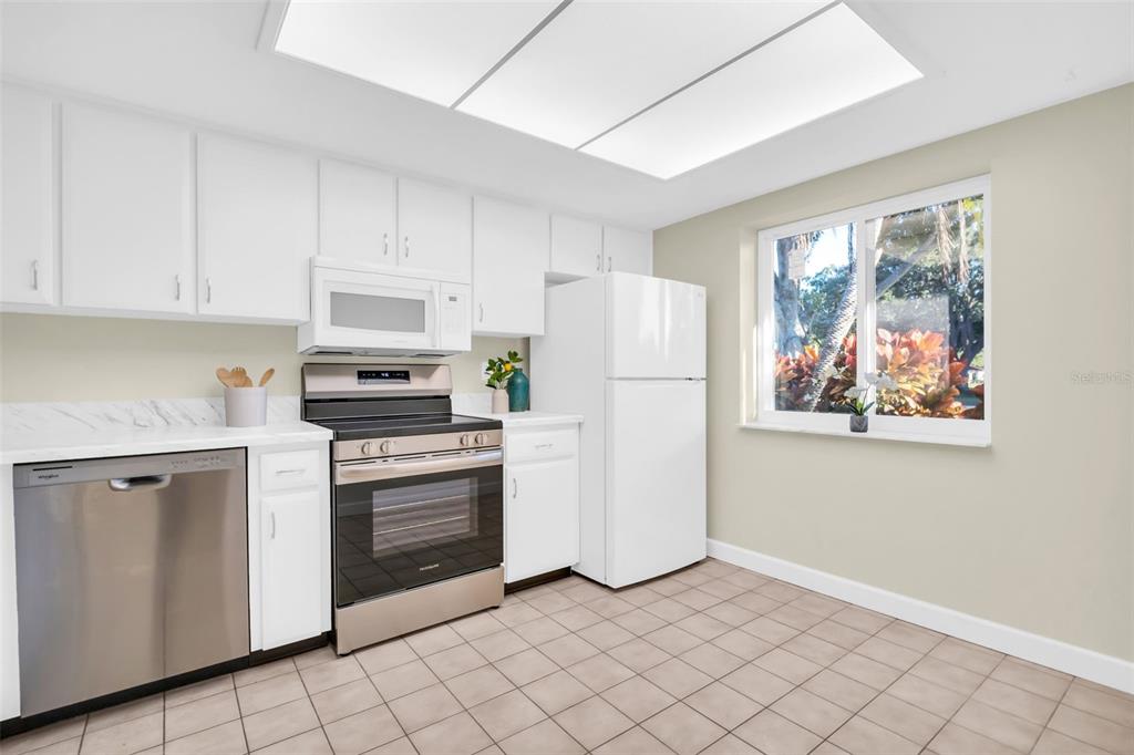 899 Cleland Court, Unit A Palm Harbor, FL 34684 - Photo 7 of 51 a kitchen with cabinets stainless steel appliances and a window