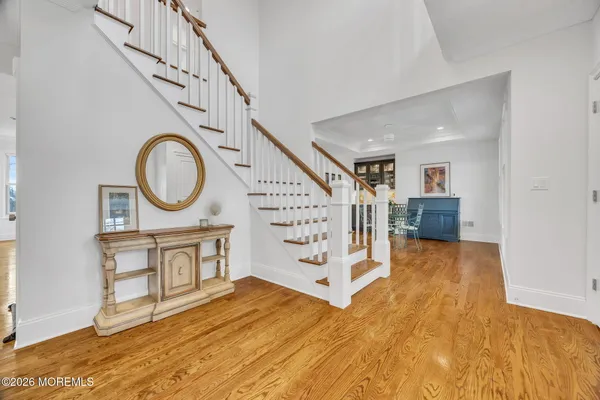 a large kitchen with kitchen island a sink a center island stainless steel appliances and a window