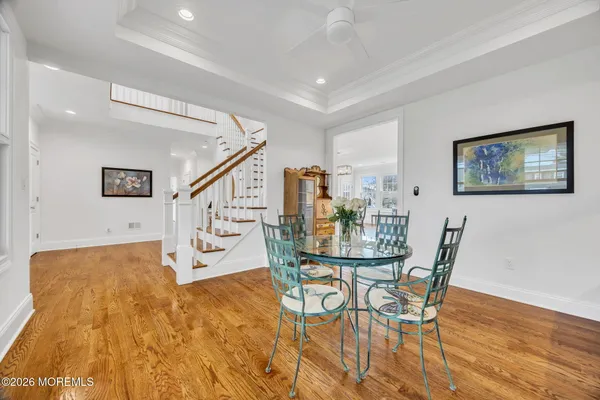 a kitchen with kitchen island a sink a stove and chairs in it