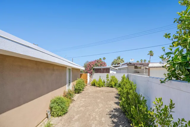 a view of a house with a yard and pathway