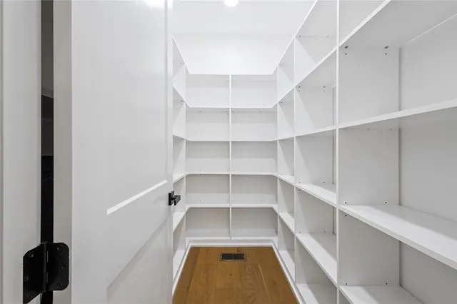 a view of walk in closet with empty racks