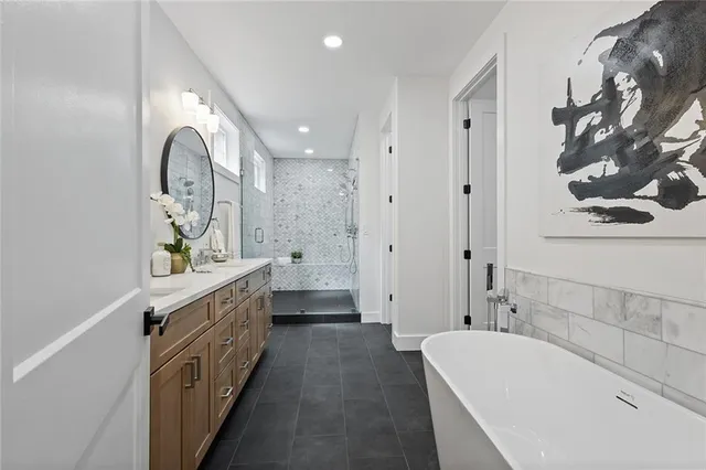 a spacious bathroom with a double vanity sink and a mirror
