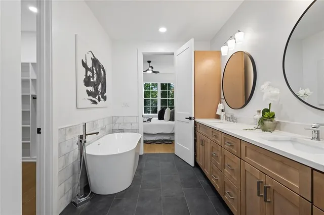 a spacious bathroom with a double vanity sink and a mirror