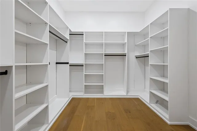 a view of walk in closet with empty racks