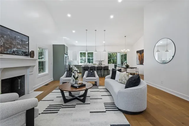 a living room with furniture a fireplace and a large window