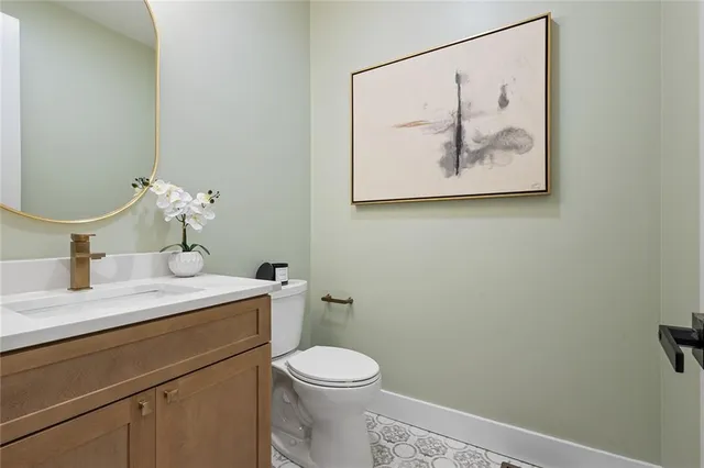 a bathroom with a toilet a sink and mirror