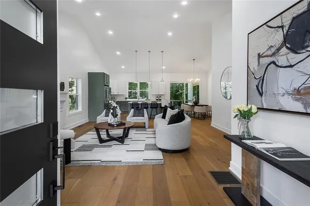 a living room with dining room and wooden floor