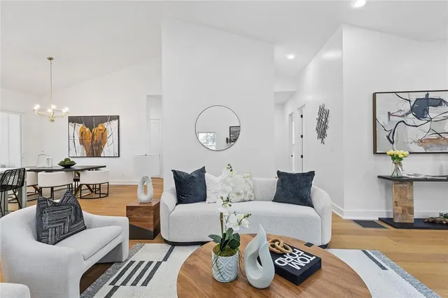 a living room with furniture and a wooden floor