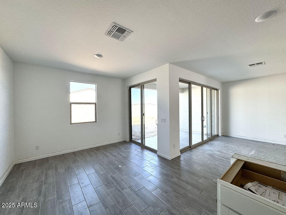 15714 West Brown Street Waddell, AZ 85355 - Photo 11 of 36 a view of an empty room with wooden floor and a window