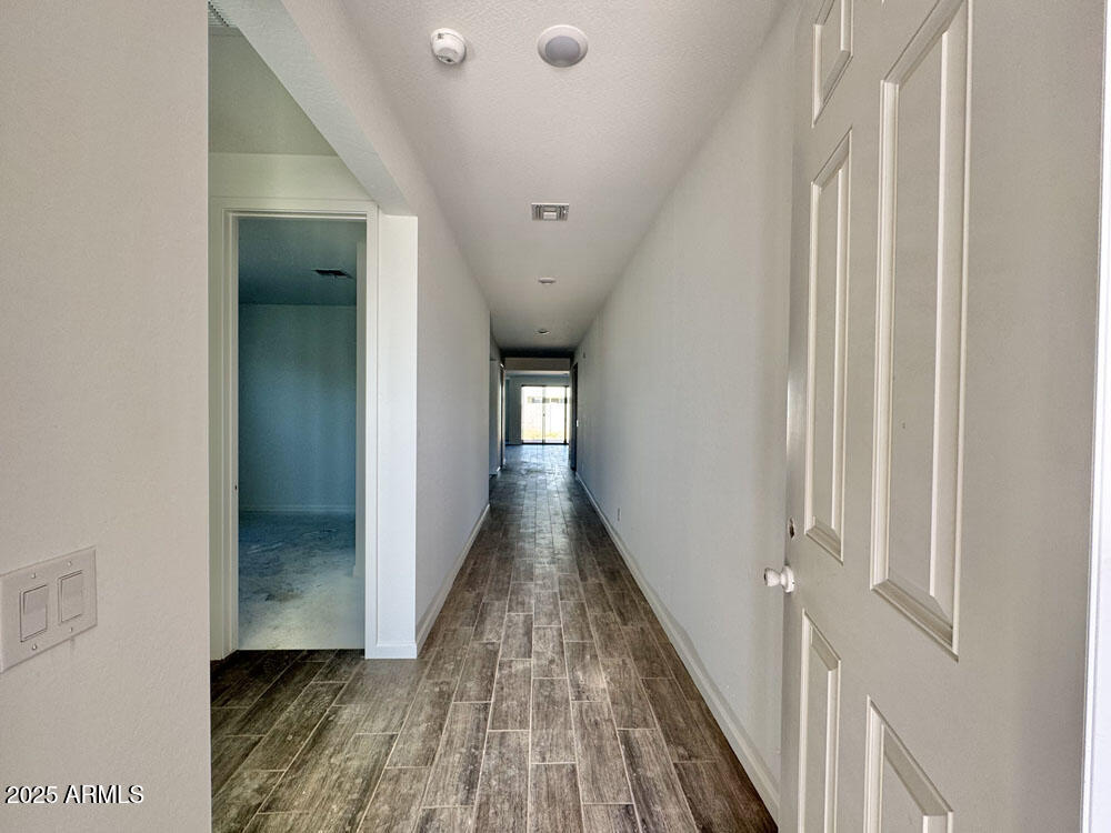 15714 West Brown Street Waddell, AZ 85355 - Photo 4 of 36 a view of a hallway with wooden floor and staircase