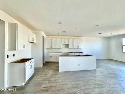 a kitchen with granite countertop a sink and a stove top oven