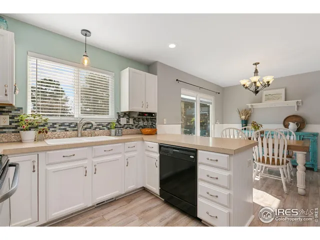 a kitchen with granite countertop a sink cabinets and window