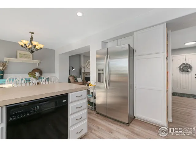 a kitchen with a refrigerator and a sink
