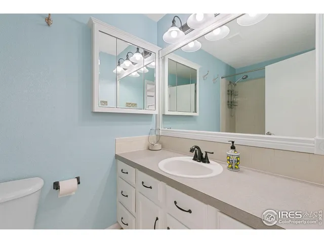 a bathroom with a sink vanity and mirror