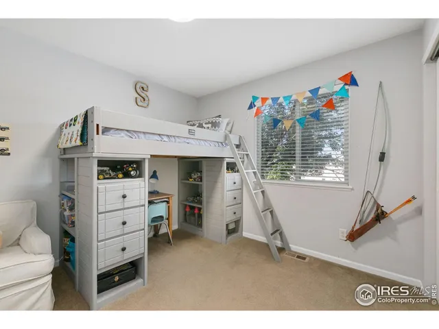 a view of a bedroom with furniture and windows
