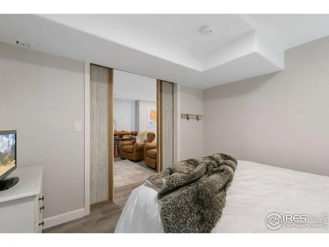 a bed room with a bed and a television