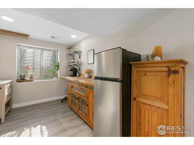 a kitchen with refrigerator cabinets and wooden floor