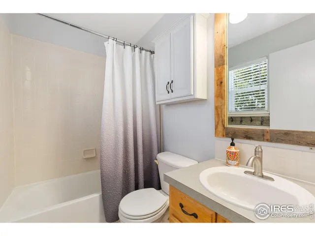 a bathroom with a sink toilet a mirror and shower