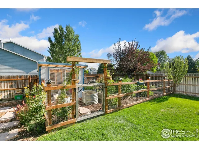 a view of a chairs and table in backyard of the house