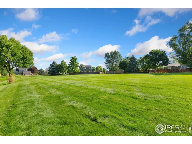 a sign board with a play ground in the back yard