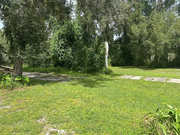 a view of outdoor space with deck and yard