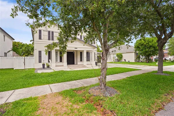 a front view of a house with yard and green space