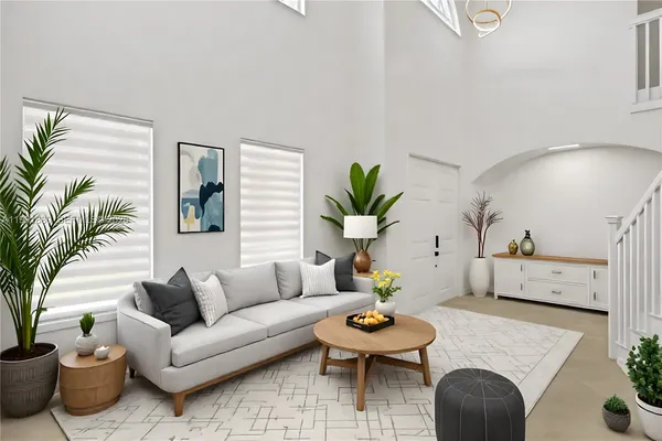 a living room with furniture and a potted plant