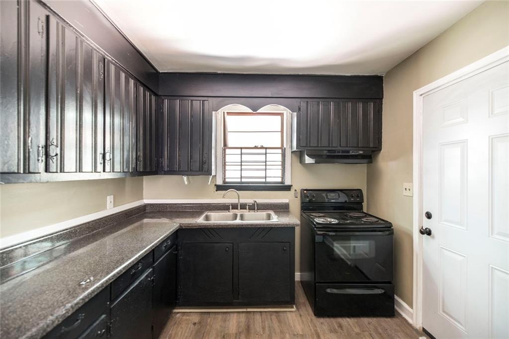 3260 Toole Drive Macon, GA 31204 - Photo 13 of 26 a kitchen with a sink a stove cabinets and a window