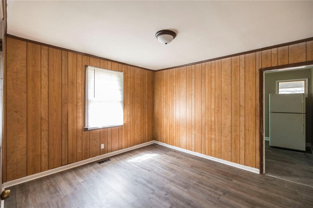 3260 Toole Drive Macon, GA 31204 - Photo 15 of 26 an empty room with wooden floor and windows