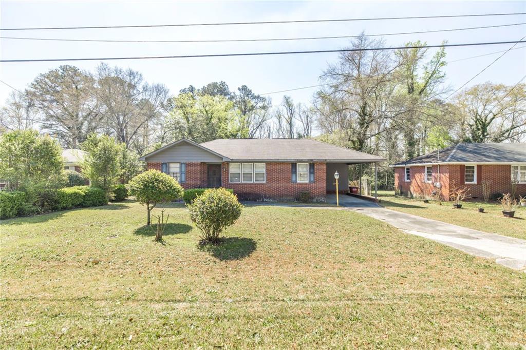 3260 Toole Drive Macon, GA 31204 - Photo 2 of 26 a front view of a house with a yard and trees