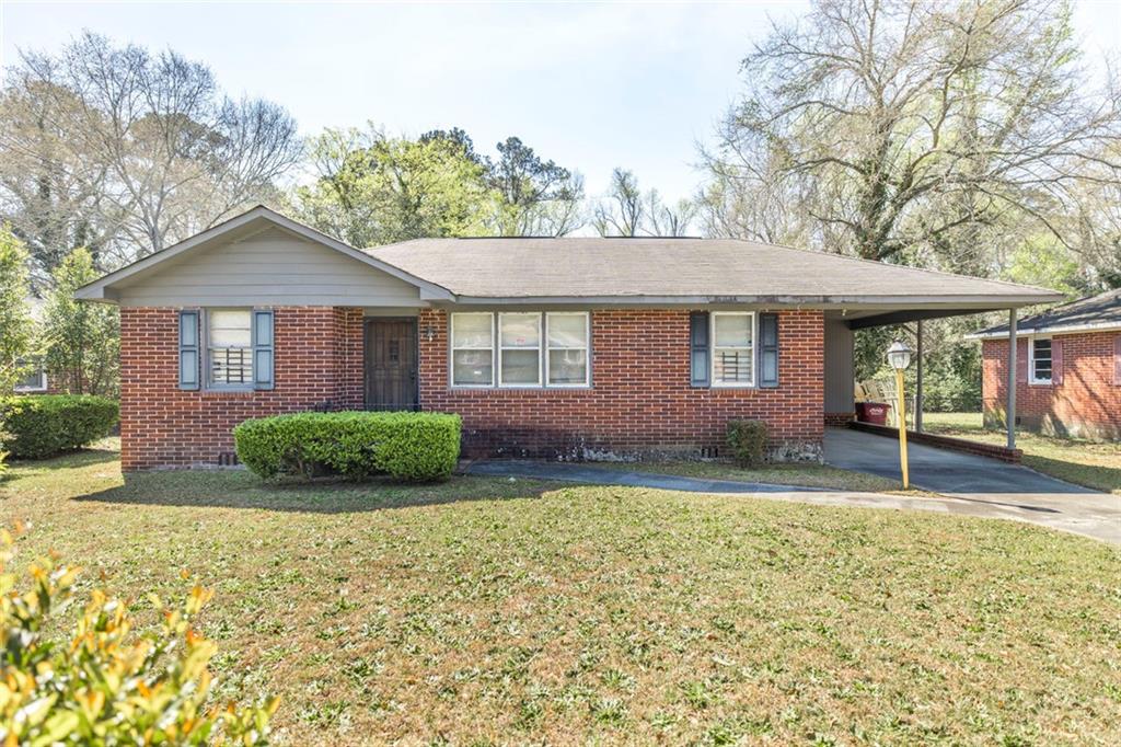 3260 Toole Drive Macon, GA 31204 - Photo 4 of 26 front view of a house with a yard