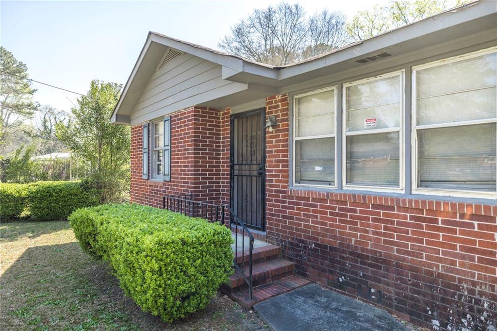 3260 Toole Drive Macon, GA 31204 - Photo 7 of 26 a front view of a house with garden