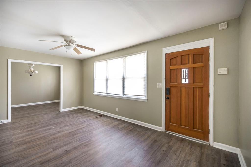 3260 Toole Drive Macon, GA 31204 - Photo 8 of 26 a view of an empty room with window and wooden floor