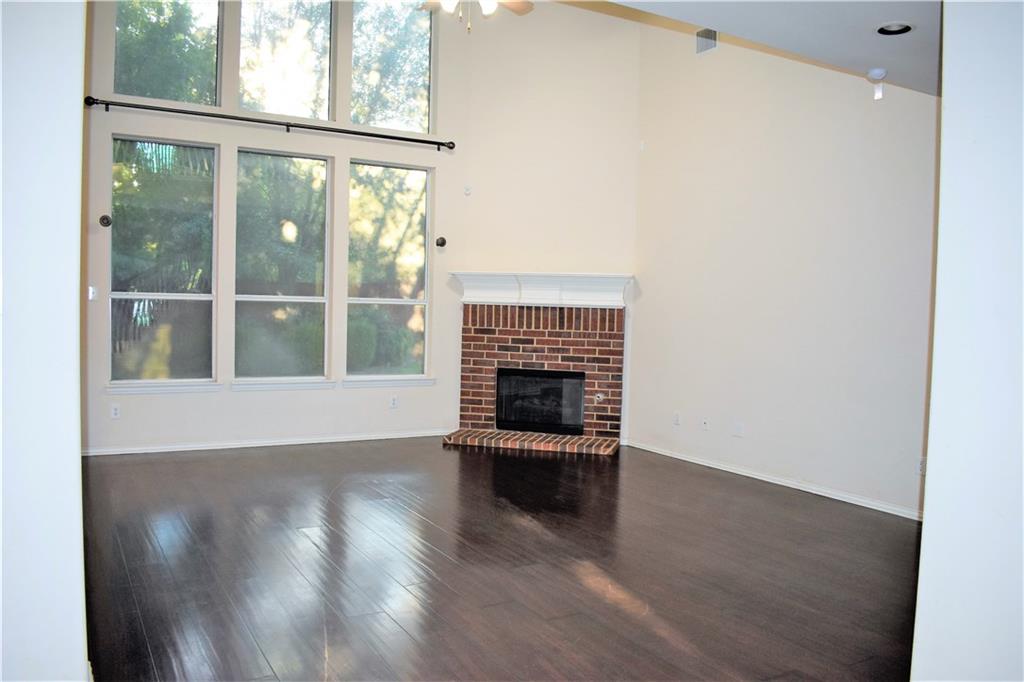 3821 Sandlin Street Grapevine, TX 76092 - Photo 13 of 26 a view of an empty room with wooden floor and a window
