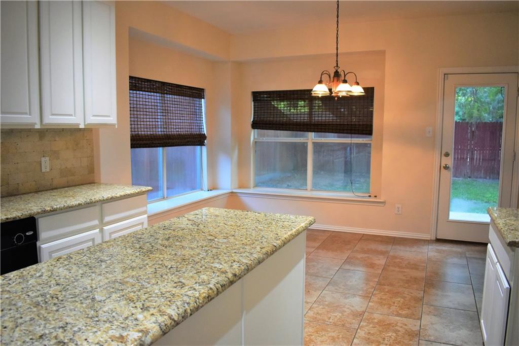 3821 Sandlin Street Grapevine, TX 76092 - Photo 16 of 26 a kitchen with granite countertop sink and cabinets