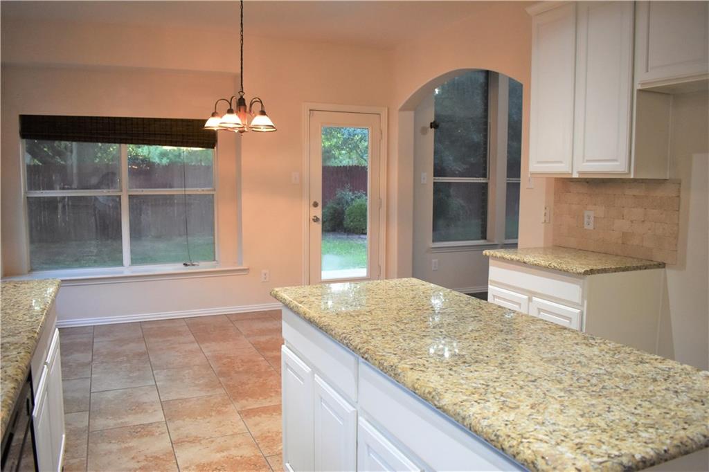 3821 Sandlin Street Grapevine, TX 76092 - Photo 17 of 26 a kitchen with kitchen island a counter top space appliances and cabinets