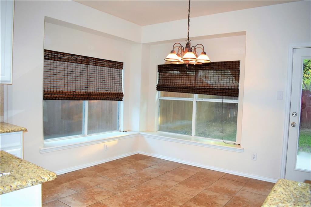 3821 Sandlin Street Grapevine, TX 76092 - Photo 18 of 26 a living room with a large window and chandelier