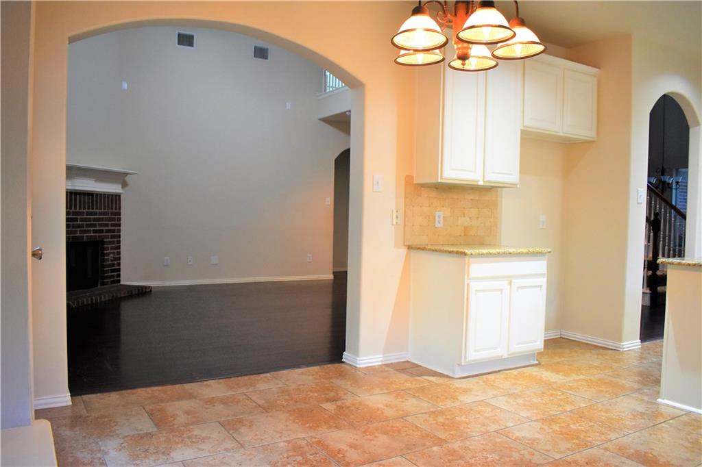 3821 Sandlin Street Grapevine, TX 76092 - Photo 19 of 26 a view of a kitchen with wooden cabinet and entryway