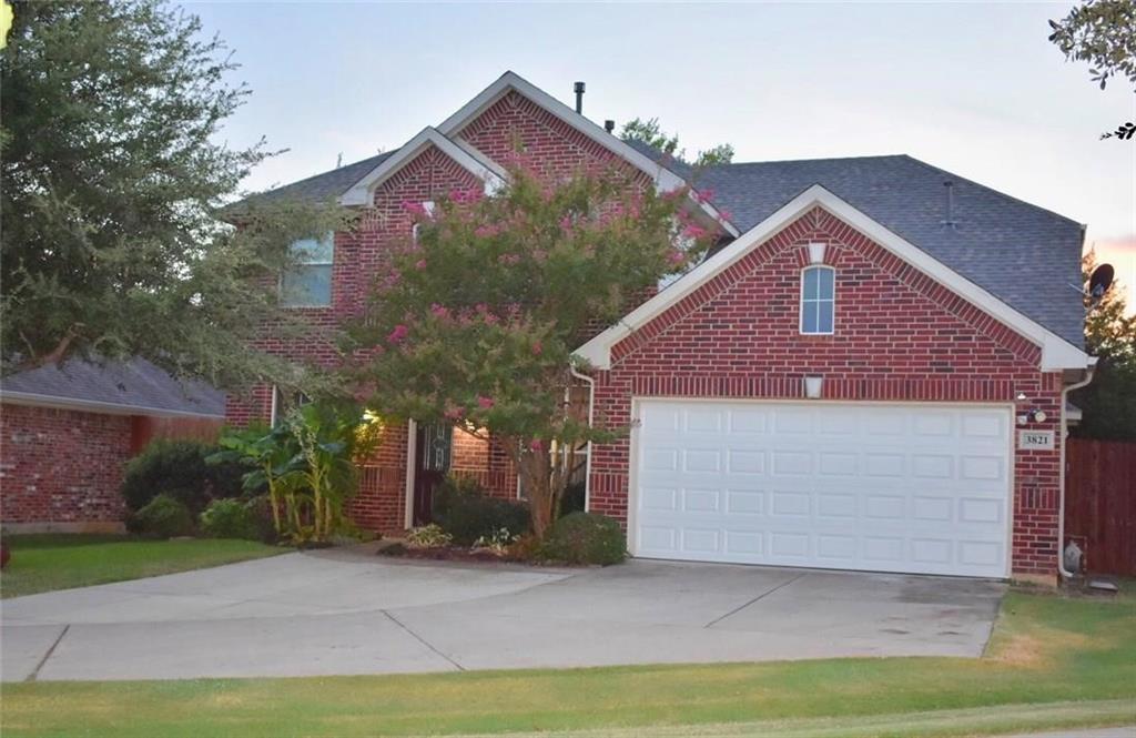 3821 Sandlin Street Grapevine, TX 76092 - Photo 2 of 26 a front view of a house with a yard and garage