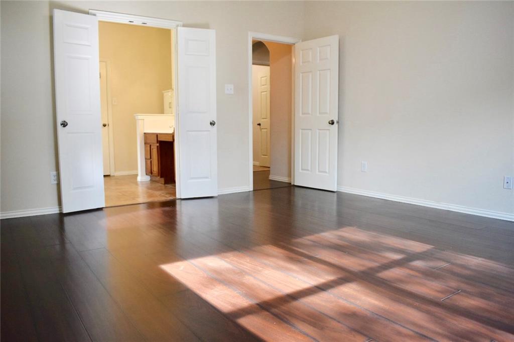 3821 Sandlin Street Grapevine, TX 76092 - Photo 21 of 26 a view of an empty room with wooden floor and a window