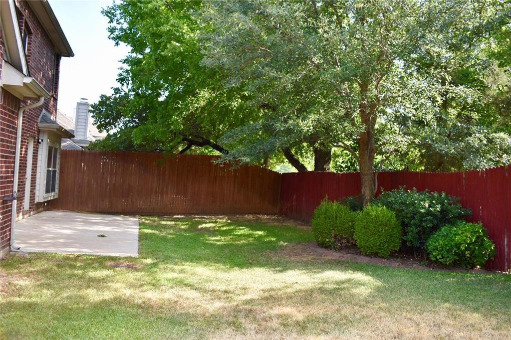 3821 Sandlin Street Grapevine, TX 76092 - Photo 22 of 26 a backyard of a house with lots of green space