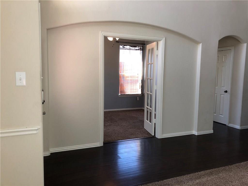 3821 Sandlin Street Grapevine, TX 76092 - Photo 3 of 26 an empty room with wooden floor and windows