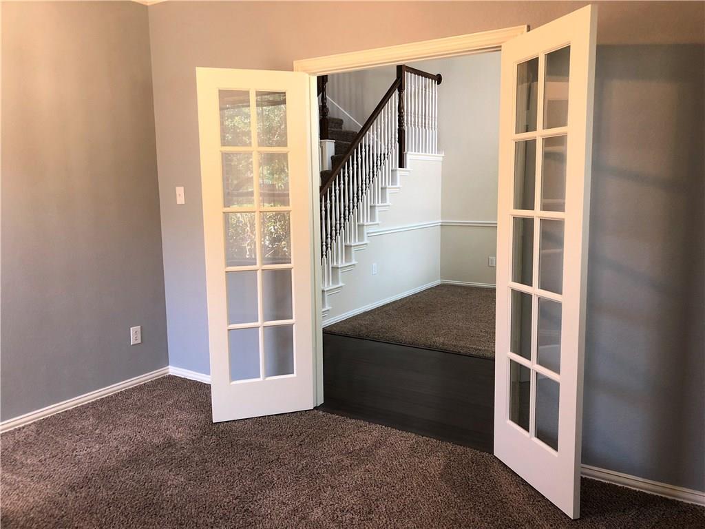 3821 Sandlin Street Grapevine, TX 76092 - Photo 6 of 26 a view of an empty room with wooden floor and windows