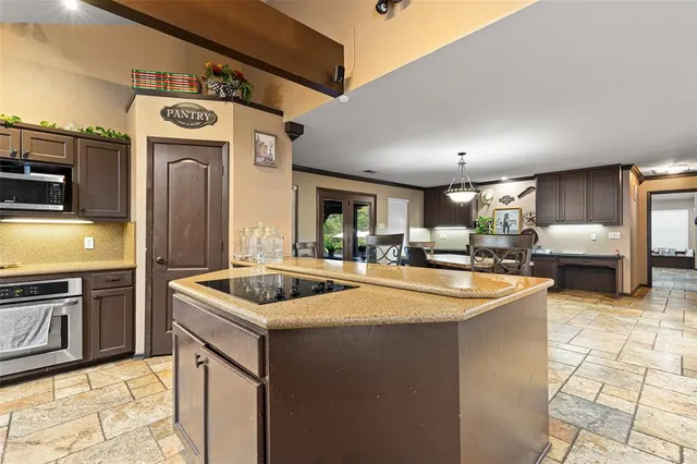 a kitchen with stainless steel appliances granite countertop a sink and a stove