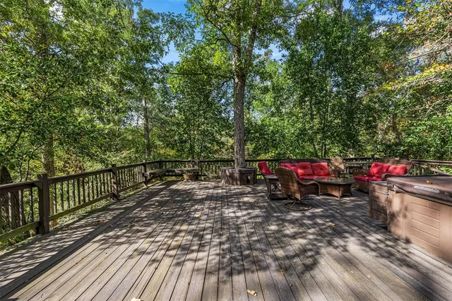 a view of roof deck with wooden floor and seating space