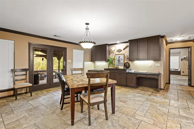 a kitchen with granite countertop wooden cabinets a counter and chairs