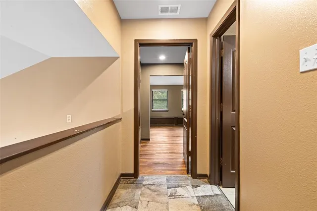 a view of a hallway with a room