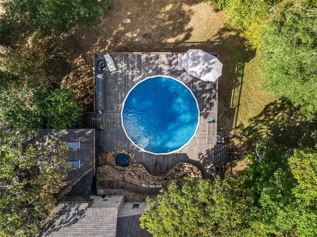 an aerial view of a house with garden space and outdoor seating