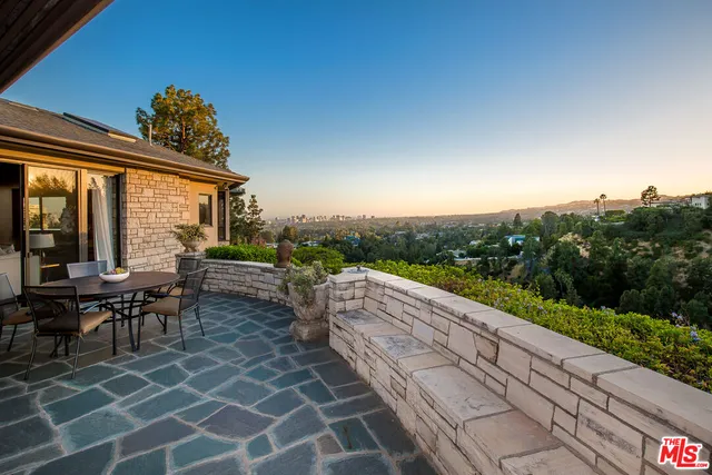 a view of a patio with table and chairs and potted plants