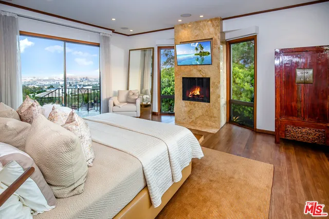 a spacious bedroom with a bed and a large window